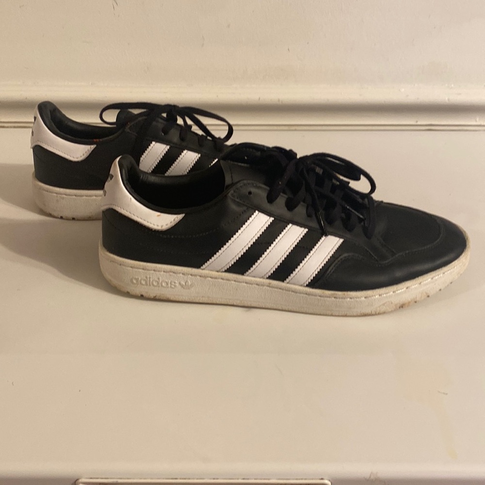 Black and white adidas shoes.